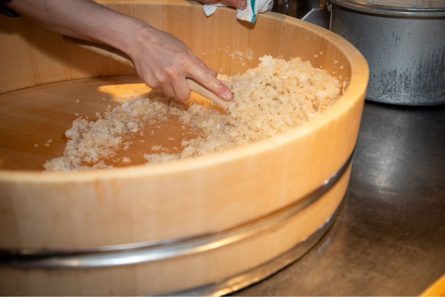 A chef preparing rice by hand