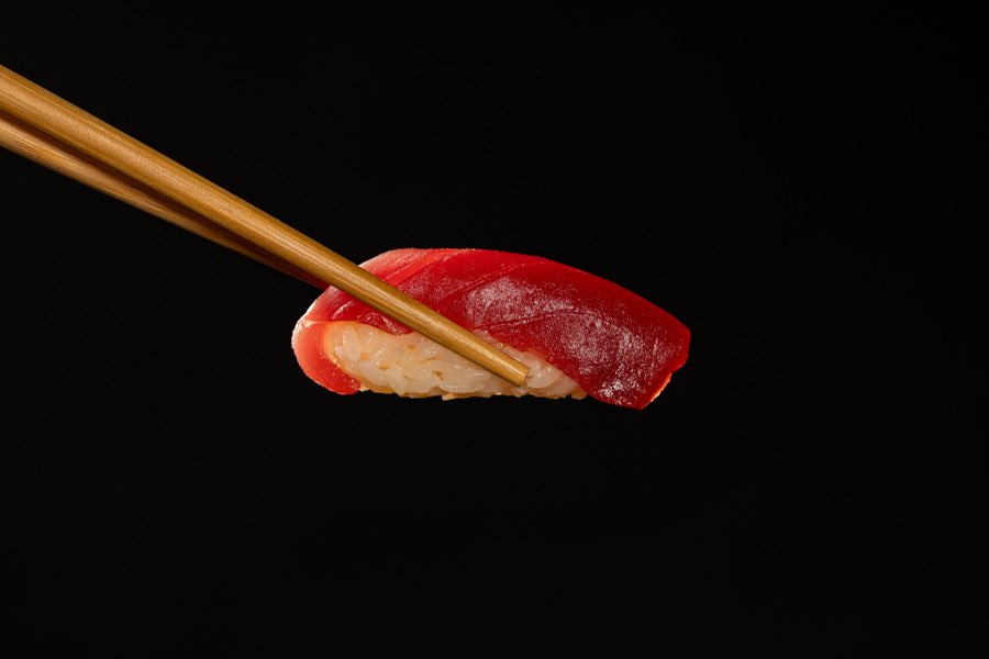 Nigiri lifted with chopsticks